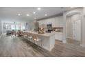 Spacious kitchen with modern appliances, large island, and seamless flow to dining area at 212 Villa Luna Ln, Lutz, FL 33549