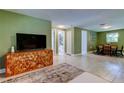Open-concept living area with stylish console and access to the dining room at 2750 Edenwood St, Clearwater, FL 33759