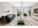 Stylish living room showcasing plush velvet seating and sun-filled sliding glass doors at 31355 Amberview Bnd, Wesley Chapel, FL 33545