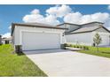 Well-maintained home with a spacious two-car garage and freshly cut lawn at 31647 Malbec Dr, Brooksville, FL 34602