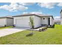 Inviting single-Gathering home with a two-car garage, tidy landscaping, and sidewalk entrance at 31647 Malbec Dr, Brooksville, FL 34602