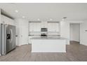 Modern kitchen with stainless steel appliances, granite countertops, and a center island at 31647 Malbec Dr, Brooksville, FL 34602