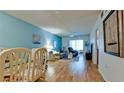 Inviting living room featuring a large window, hardwood floors, neutral wall color, and a comfortable seating area at 3534 Lake Bayshore Dr # 118, Bradenton, FL 34205