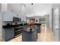Modern kitchen featuring stainless steel appliances, dark granite countertops, and tile flooring at 3703 Treeline Dr, Valrico, FL 33596