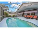 Relaxing screened-in pool area featuring an in-ground pool, covered patio, and comfortable seating at 3703 Treeline Dr, Valrico, FL 33596