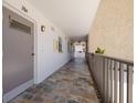 Well-maintained hallway with stone accents, leading to the condo unit's entrance at 3789 46Th S Ave # 204, St Petersburg, FL 33711