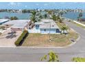 A charming waterfront home on a sunny day, featuring well-maintained landscaping at 399 161St Ave, Redington Beach, FL 33708