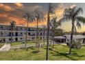 Beautiful condo complex featuring a green space, clubhouse, and palm trees at 4050 4Th N St # 205, St Petersburg, FL 33703