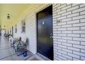 White brick hallway featuring chairs and unit number 205 at 4050 4Th N St # 205, St Petersburg, FL 33703