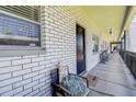 White brick hallway featuring chairs, plants, and natural light at 4050 4Th N St # 205, St Petersburg, FL 33703