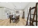 Dining area with bright natural light, light wood floors, and built in bar with wine fridge at 4203 W Cleveland St, Tampa, FL 33609