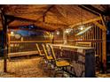Thatched tiki bar with seating, fun decor, and a relaxed ambiance for outdoor entertaining and relaxation at 4301 S Lockwood Ridge Rd, Sarasota, FL 34231