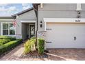Close up of the house's entrance, showing detailed landscaping and a glimpse of the front door at 4620 Ballast Crest Cv, Land O Lakes, FL 34638
