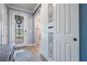 Bright foyer with decorative glass front door and decorative sliding barn door at 4620 Ballast Crest Cv, Land O Lakes, FL 34638