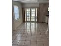 Dining room area featuring tile flooring and french doors that lead to the patio at 5008 N Suwanee Ave, Tampa, FL 33603