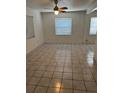 Bright living room featuring tile flooring, natural light and a ceiling fan at 5008 N Suwanee Ave, Tampa, FL 33603