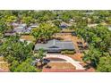 Aerial view of a home surrounded by mature trees, showcasing the property's expansive lot and neighborhood at 504 7Th Sw Ave, Largo, FL 33770