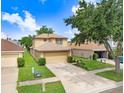Charming two-story home features a well-maintained front yard, a two-car garage, and a welcoming entryway at 5525 Turtle Crossing Loop, Tampa, FL 33625