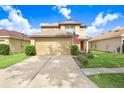 Charming two-story home features a well-maintained front yard, a two-car garage, and a welcoming entryway at 5525 Turtle Crossing Loop, Tampa, FL 33625