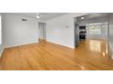 Bright living room featuring shiny hardwood floors, white walls, and an open layout at 5642 9Th N Ave, St Petersburg, FL 33710