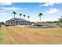 Spacious property showcasing a circular driveway, mature palm trees, and lush landscaping that adds to the home's charm at 602 Swilley Rd, Plant City, FL 33567
