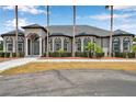 Beautiful home with arched windows, well-maintained landscaping, and a neatly paved walkway leading to a welcoming entrance at 602 Swilley Rd, Plant City, FL 33567