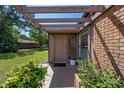 Inviting front entrance with a covered porch, brick accents, lush landscaping, and a stylish front door at 6101 Willow Oak Cir, Bradenton, FL 34209