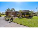 Charming single-story home with an attached garage and well-maintained landscaping on a sunny day at 6101 Willow Oak Cir, Bradenton, FL 34209