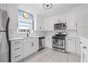 Bright, renovated kitchen featuring stainless steel appliances and white cabinets with modern hardware at 6188 80Th N St # 101, St Petersburg, FL 33709