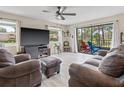 Cozy living room with comfortable leather seating and access to a screened lanai at 6188 80Th N St # 101, St Petersburg, FL 33709