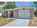 Charming single Gathering home featuring a decorative front door and a one car garage at 6309 7Th Ave, New Port Richey, FL 34653