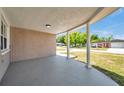 Covered front porch with decorative columns and a view of the well-maintained neighborhood at 6309 7Th Ave, New Port Richey, FL 34653