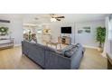 Cozy living room with modern furniture, a large gray sofa, and bright natural light at 6490 22Nd S St, St Petersburg, FL 33712