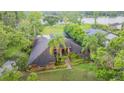 Stunning home featuring lush landscaping, mature palms, and well-maintained lawn at 707 Warren Rd, Lutz, FL 33548