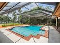 Enclosed pool area featuring a refreshing swimming pool and a beautiful backyard at 707 Warren Rd, Lutz, FL 33548