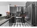 Modern kitchen features black cabinets, stainless steel appliances, and designer backsplash at 727 Coral Reef Dr, Tampa, FL 33602