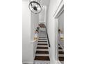 Staircase with white risers and dark wood treads, featuring white walls at 727 Coral Reef Dr, Tampa, FL 33602