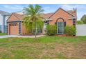 Beautiful single-Gathering house boasting well-kept lawn, garden and a healthy palm tree at 7591 121St Ter, Largo, FL 33773