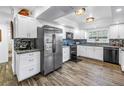 Bright kitchen featuring white cabinets, granite countertops, stainless steel appliances, and decorative backsplash at 9611 107Th N Ave, Largo, FL 33773