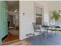 Inviting front porch with seating area, showing view to the interior of the home at 1003 E Emma St, Tampa, FL 33603