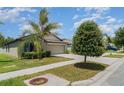 Charming one-story home featuring a well-maintained lawn and a spacious two-car garage at 10104 Carloway Hills Dr, Wimauma, FL 33598