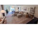 Spacious living room with a large sectional sofa, open to the dining area and bathed in natural light at 10123 Carp Hollow Rd, Sun City Center, FL 33573