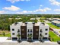 Aerial view showcasing the contemporary townhome architecture and lush surroundings of the community at 10340 2Nd N Way, St Petersburg, FL 33716