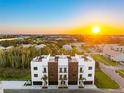 Stunning aerial view of modern townhomes with rooftop terraces and a vibrant sunset backdrop at 10340 2Nd N St, St Petersburg, FL 33716