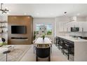 Open-concept living space with stylish decor, modern lighting, and a seamless flow into the kitchen at 10340 2Nd N Way, St Petersburg, FL 33716