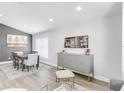 Bright dining room features recessed lighting, hardwood floors, and a decorative bar at 11324 Cypress Reserve Dr, Tampa, FL 33626