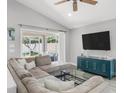 Spacious living room boasts a large sectional sofa, flat screen TV, and sliding glass doors to the porch at 11324 Cypress Reserve Dr, Tampa, FL 33626