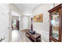 Spacious foyer with light gray walls, wood floors, and a glimpse into other living spaces at 11623 Tetrafin Dr, Riverview, FL 33579
