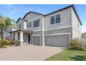 Attractive home featuring a three-car garage, manicured lawn, and a welcoming front entrance at 11726 Sunburst Marble Rd, Riverview, FL 33579