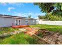 Spacious backyard featuring a fire pit, brick accents, and a cozy deck area at 11809 129Th Ave, Largo, FL 33778